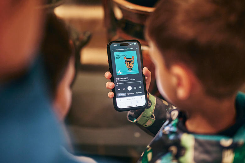 Children using their smartphone for the Myths and Reality audio tour