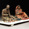 Painted clay model depicting two seated cobblers at work