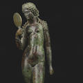 Statuette of a black Venus holding a mirror standing on a wooden plinth