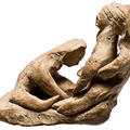 Ancient Cypriot figurine of a woman in childbirth assisted by two midwives