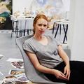 The contemporary London artist Flora Yukhnovich sitting in the Victoria Miro, 2023