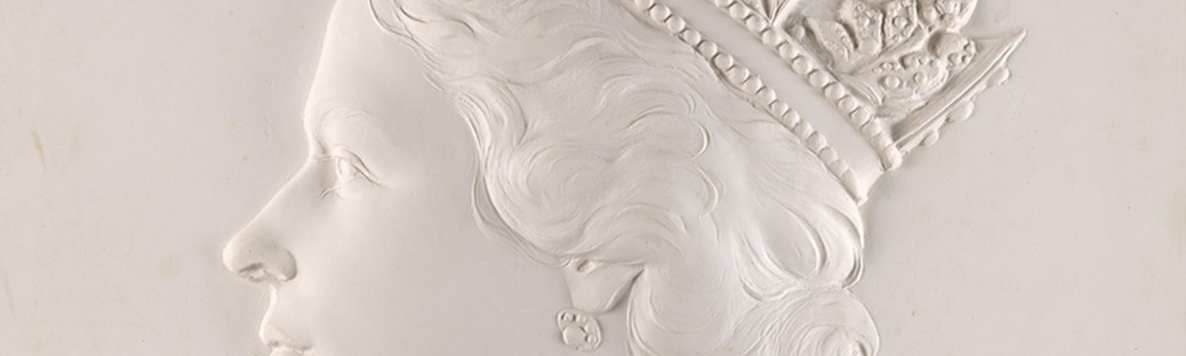 A white plaster relief 'dressed head' bust of Queen Elizabeth II - used on billions of postage stamps