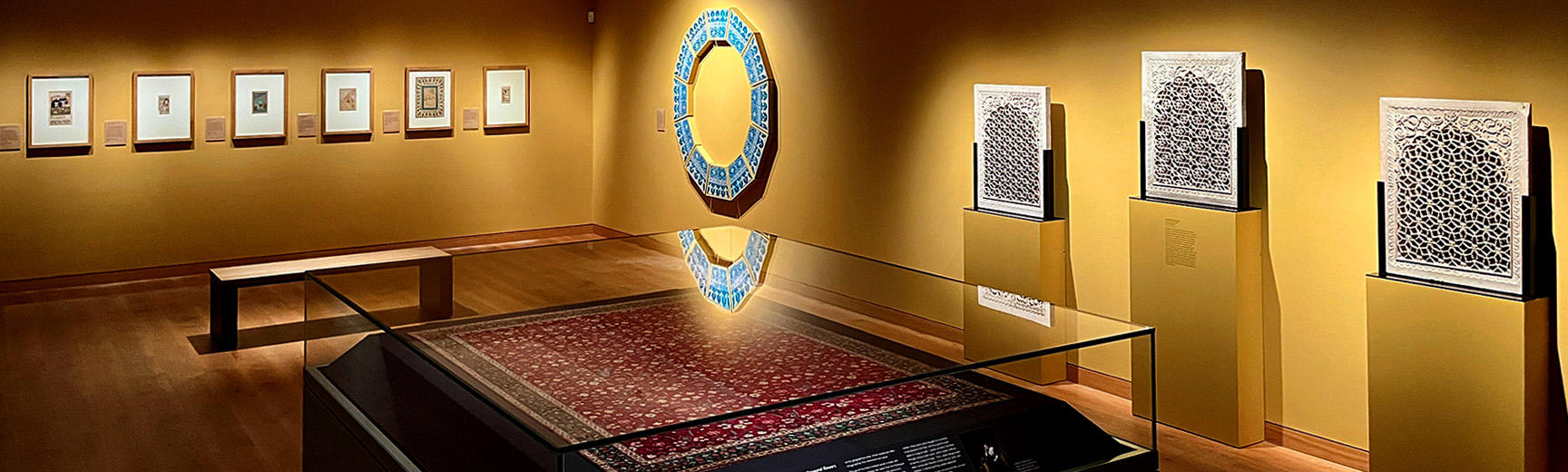 Inside the Mughal India gallery 33 showing the carpet, tiles and miniatures wall