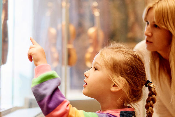 Mother and daughter looking at clocks in the galleries
