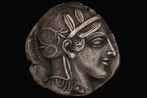 Silver coin decorated with profile of Greek warrior