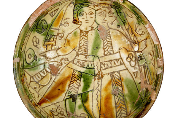 Sgraffito wedding bowl, 1191-1489 from Cyprus depicting a man and a woman, probably a newly-married couple, in green and brown coloured layers