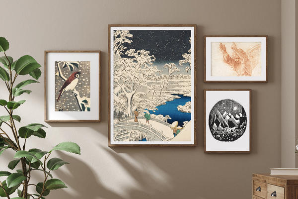 A neutral coloured room with art prints hung in frames on a wall