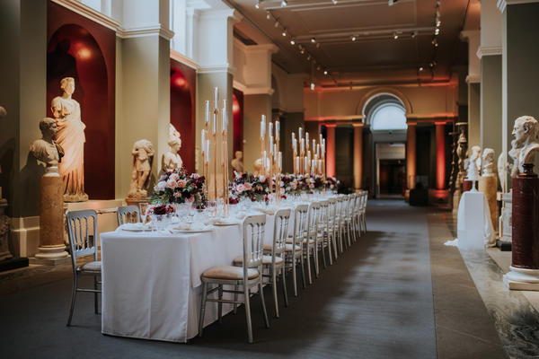 The Sculpture Gallery with a long table in the centre set for a dinner