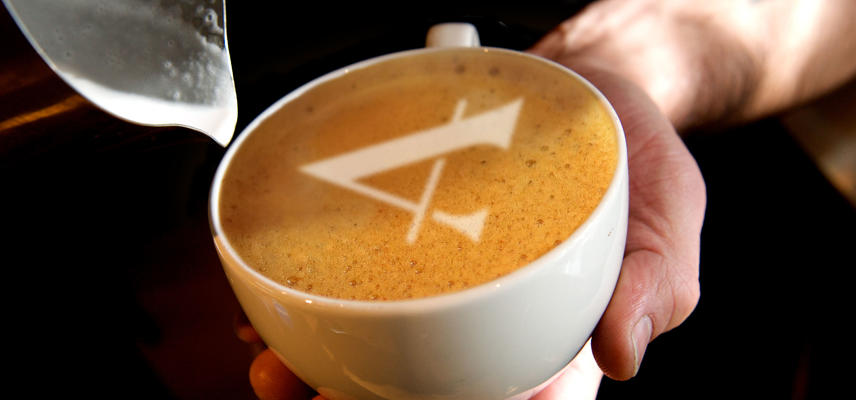 A coffee with the Ashmolean A-logo