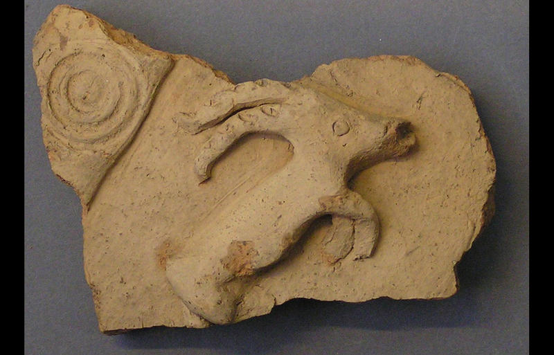 Pottery vessel fragment showing a wild goat in relief