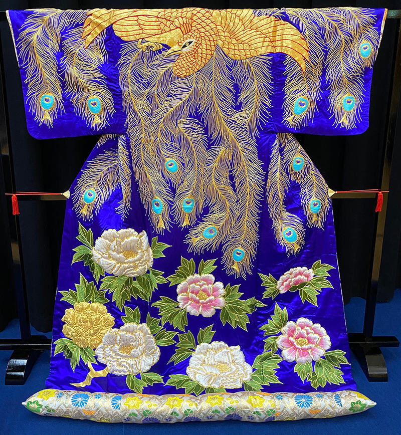 Kabuki kimono in blue silk depicting white and pink flowers and peacock feathers