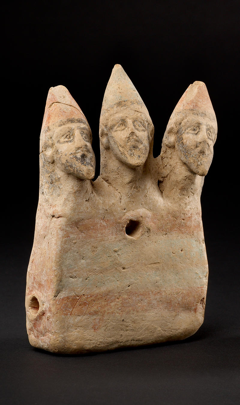 Toy figurine showing three warriors on a chariot in an abstract shape 750–480 BC Cyprus AN1968.1524 A stone sculpture of three male heads