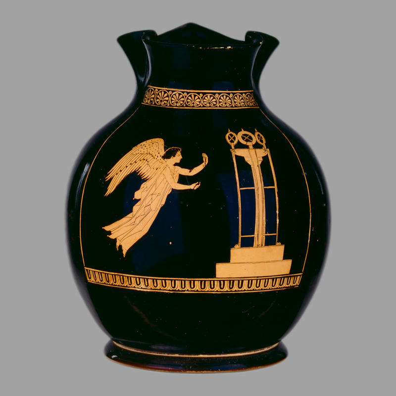 An ancient Greek black jug with a winged figure in orange