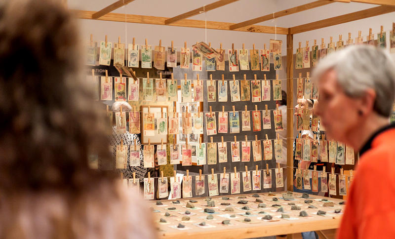 Bank or Economy – Inflation © Meschac Gaba, 2016 Installation, courtesy of Stevenson, Cape Town, Johannesburg, and Amsterdam Visitors looking at the Bank or Economy – Inflation banknotes installation by Meschac Gaba in our Money Talks exhibition