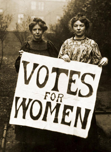 Women's rights campaigners Annie Kenney and Christabel Pankhurst holding a Votes for Women placard in about 1908. © Public domain, via Wikimedia Commons Women's rights campaigners Kenny and Pankhurst holding a Votes for Women placard, the black and white photograph was taken around 1908