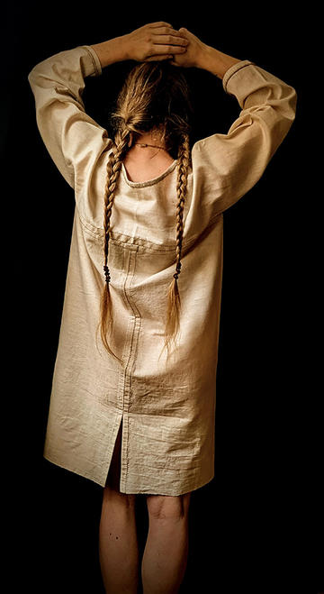 Author Nicole deRushie wearing an example of 'Bog' prehistoric fashion showing the back of the dress
