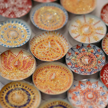One world 2019 Tea lights painted with colourful patterns