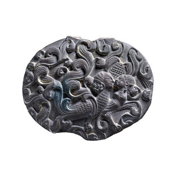 Carved box lid decorated with swirling motifs and two half-bird half-human figures