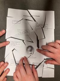 Students hands reconstructing a cut-up biography of Francis Douce