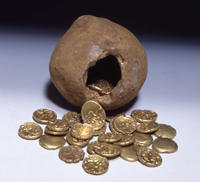 Photo of open pot with gold coins spilling out